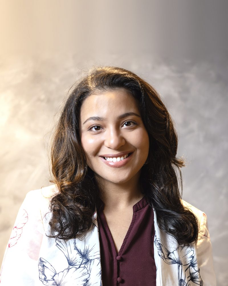Hoda Ammar, Licensed Professional Counselor, smiling in a floral jacket